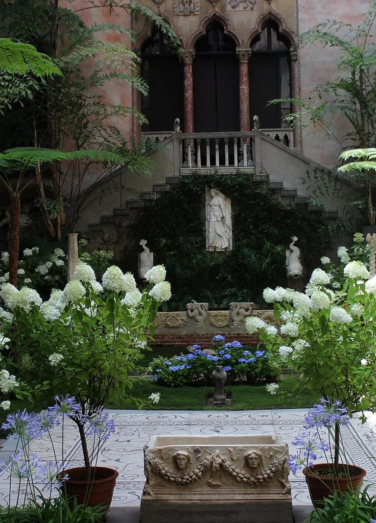 Looking across the planted courtyard of the Isabella Stewart Gardner Museum toward its arched Venetian balconies