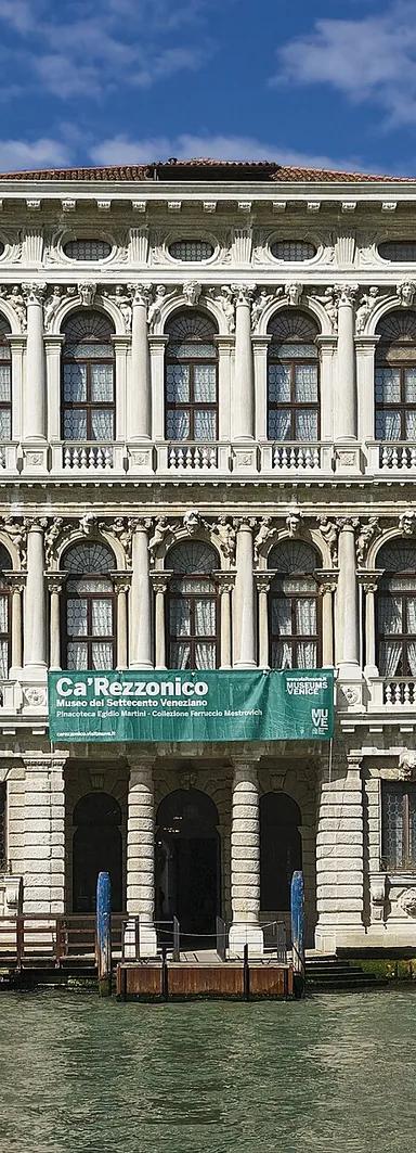 The white stone facade of Ca' Rezzonico on the Grand Canal, Venice