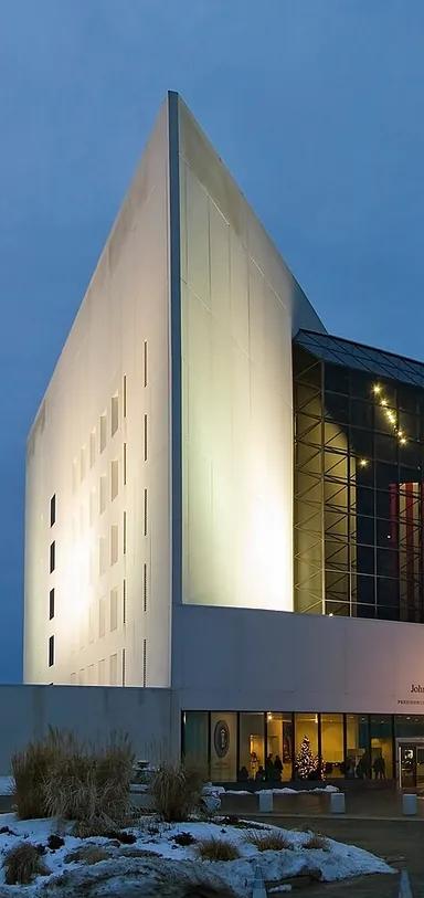 The white concrete tower and glass pavilion of the John F. Kennedy Presidential Library and Museum, designed by I. M. Pei, seen from across the water at Columbia Point, Boston