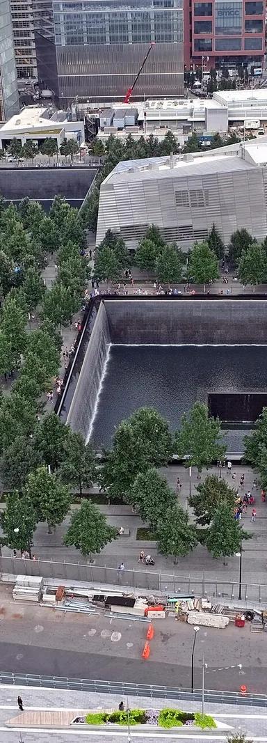 Exterior of the National September 11 Memorial & Museum at the World Trade Center site, with a reflecting pool in the foreground
