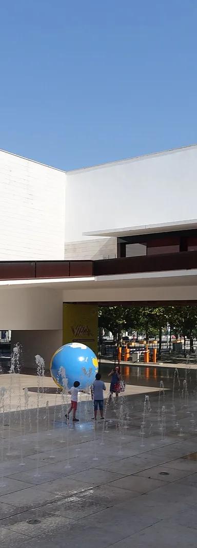 The white volumes and fountain plaza of the Pavilhão do Conhecimento in Parque das Nações, Lisbon