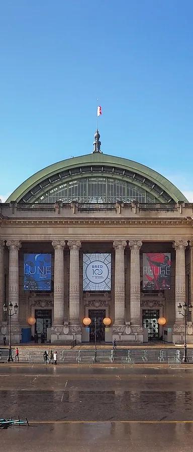 The Beaux-Arts stone facade and glass dome of the Grand Palais in Paris