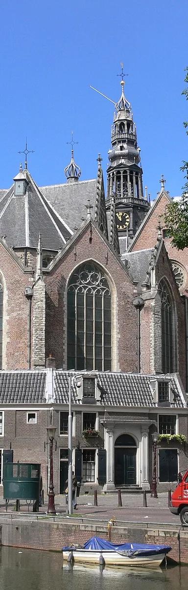 Exterior view of the Oude Kerk in Amsterdam, showing its brick facade and bell tower