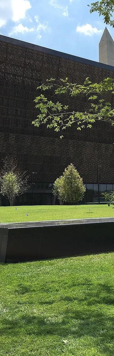 Exterior of the National Museum of African American History and Culture, its three-tiered bronze-coloured filigree corona seen from the National Mall