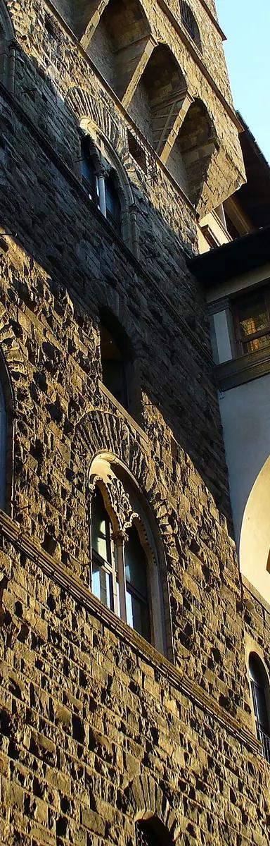 The Vasari Corridor, an elevated enclosed passageway in Florence, seen from outside showing its arched structure running above the street