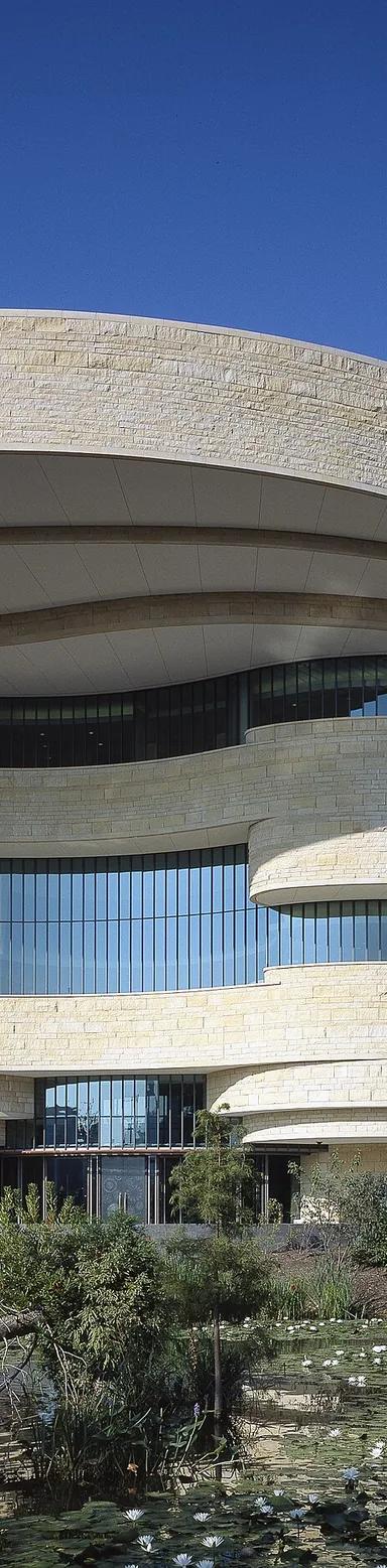 The curved Kasota limestone exterior of the National Museum of the American Indian on the National Mall in Washington, DC
