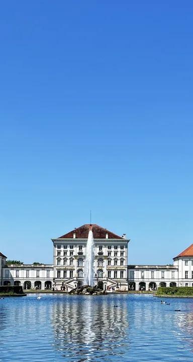 Wide-angle exterior view of the baroque facade of Nymphenburg Palace, Munich