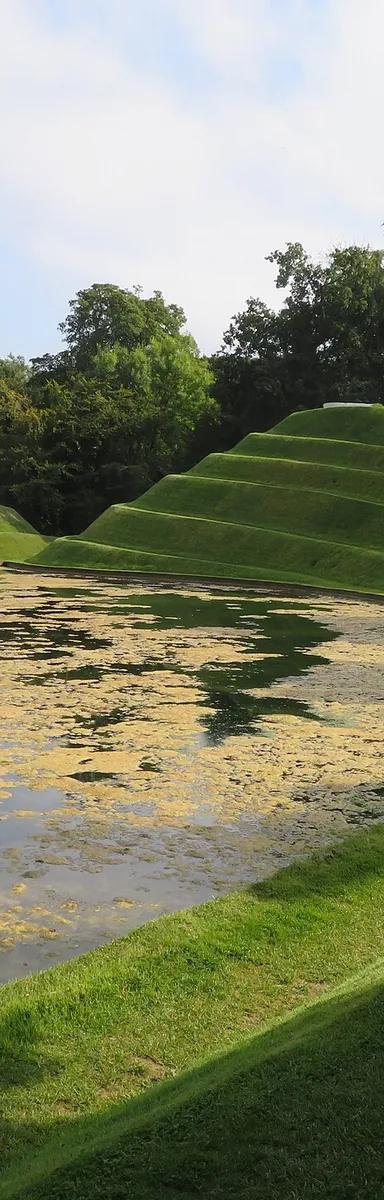 Charles Jencks's grassy Cells of Life landforms and lakes at the entrance to Jupiter Artland