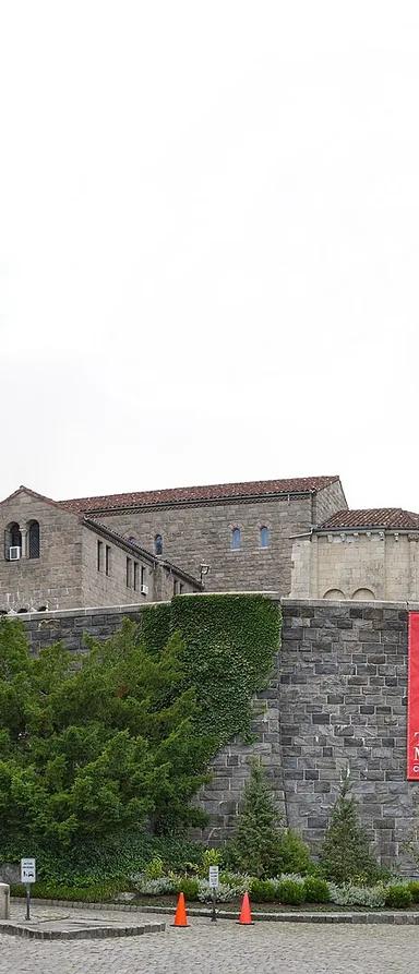 The Met Cloisters and its tower rising above Fort Tryon Park, overlooking the Hudson River
