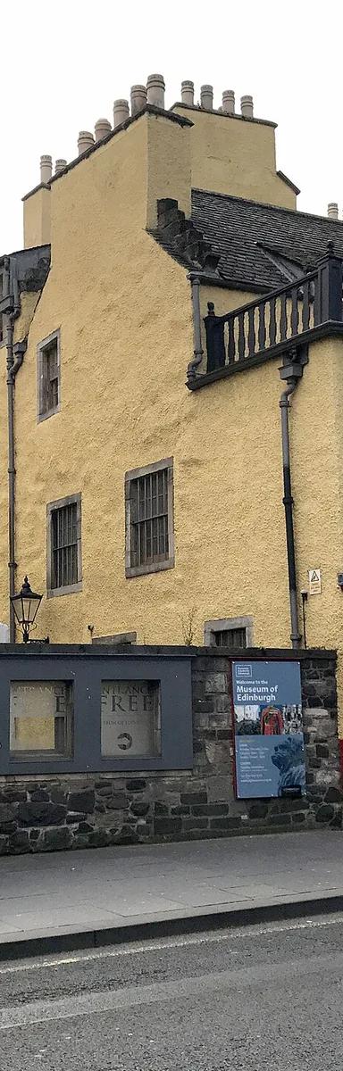 The ochre and white painted 16th-century frontage of Huntly House, home of the Museum of Edinburgh, on the Canongate