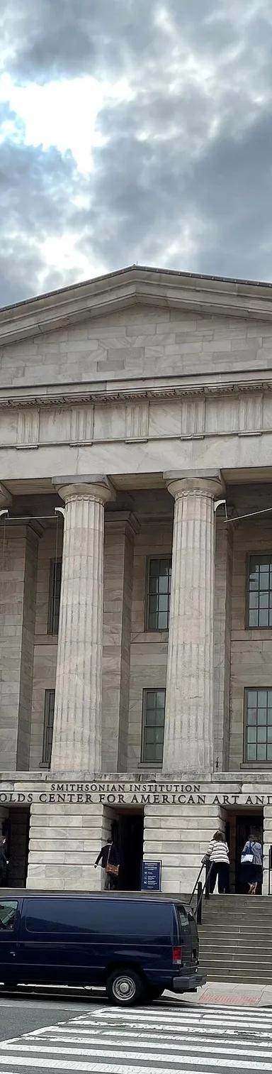 The Greek Revival portico and columned facade of the Old Patent Office Building, home of the Smithsonian American Art Museum in Washington, DC