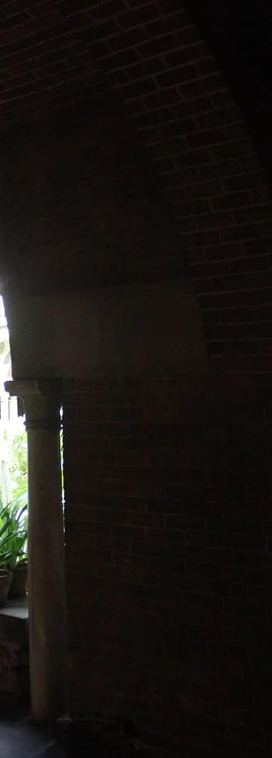 The glass-roofed central courtyard of the Isabella Stewart Gardner Museum, planted with ferns and palms and framed by Venetian Gothic arcades