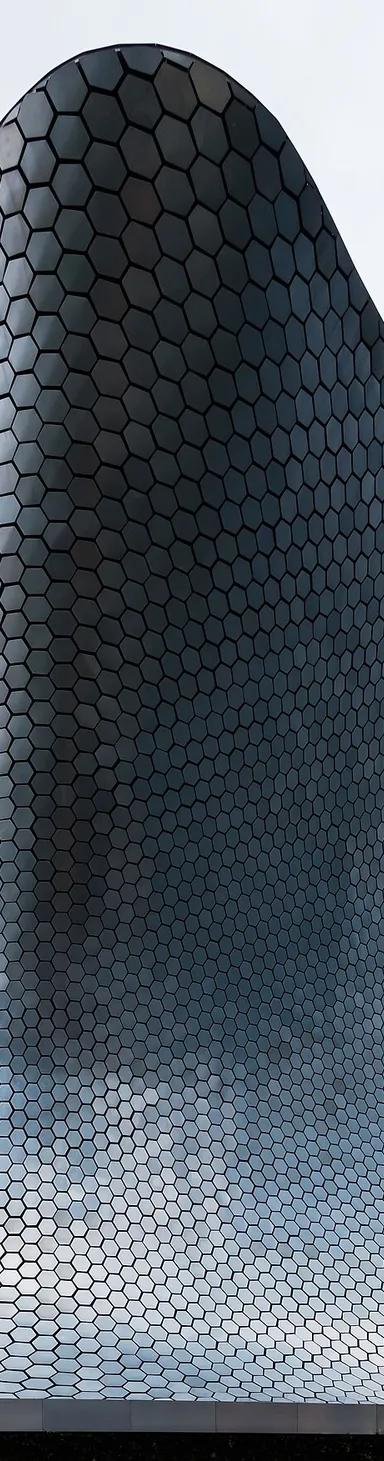 The curving, hexagon-tiled aluminium facade of Museo Soumaya Plaza Carso in Mexico City