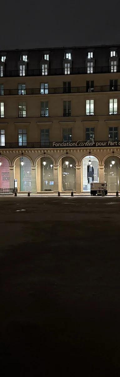 The Fondation Cartier pour l'art contemporain in its arcaded Second Empire building on place du Palais-Royal, Paris, at night