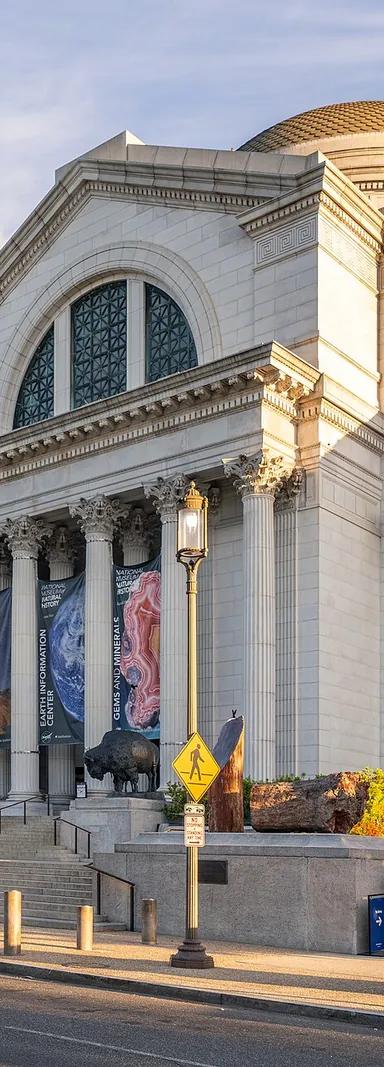Exterior of the Smithsonian National Museum of Natural History on the National Mall, its domed Beaux-Arts rotunda above a columned portico