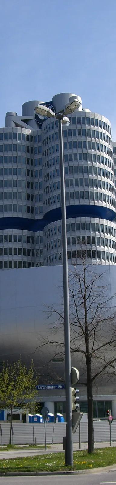 The circular BMW Museum building beside the BMW Tower in Munich